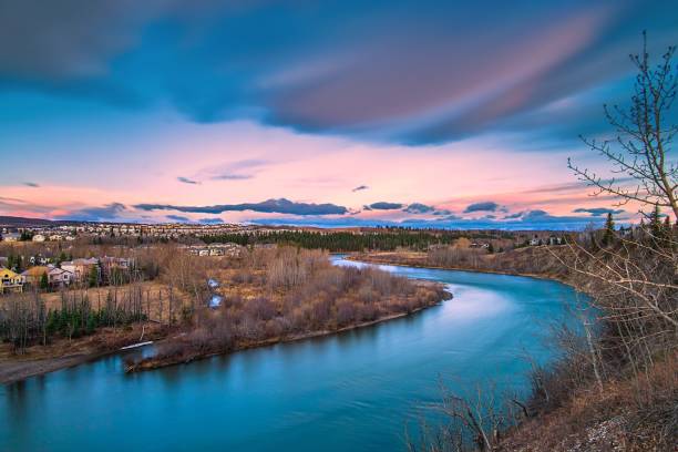 Long Exposure View Of The Bow River Valley A vivid long exposure view of clouds over the Bow river from a park lookout in Cochrane. cochrane alberta photos stock pictures, royalty-free photos & images