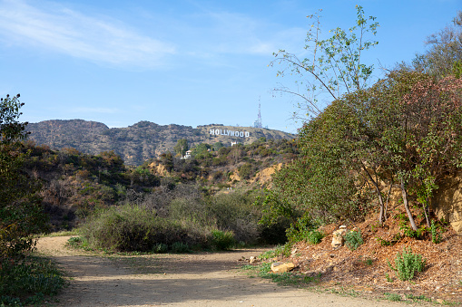 April 2021, Los Angeles California. View of Hollywood Hills with  dirt road \n and Hollywood sign