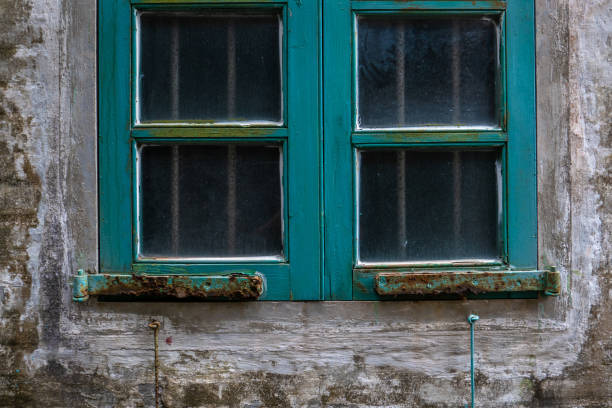 istock Window with an old iron grille on a wall 1316549434