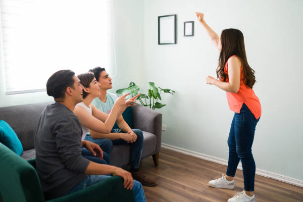 istock College student trying to act and describe a word 1316550265