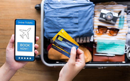 Young person using  credit  cards with smartphone for payment  ticket or booking hotel. convenient  lifestyle with technology.summer and vacation concepts