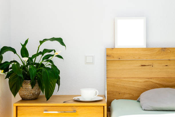 istock blooming peace lily on wooden bedside table 1316555086