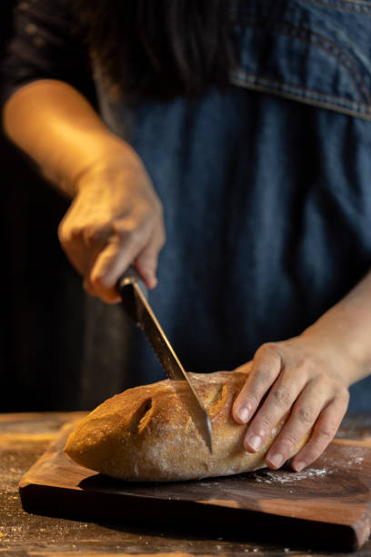 istock woman cutting rye bread with bread knife 1316556739