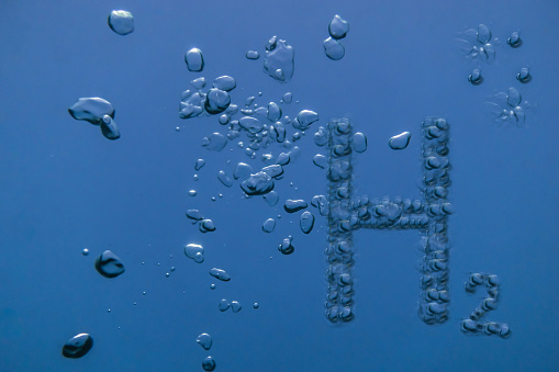 h2 hydrogen letters with many air bubbles in blue water