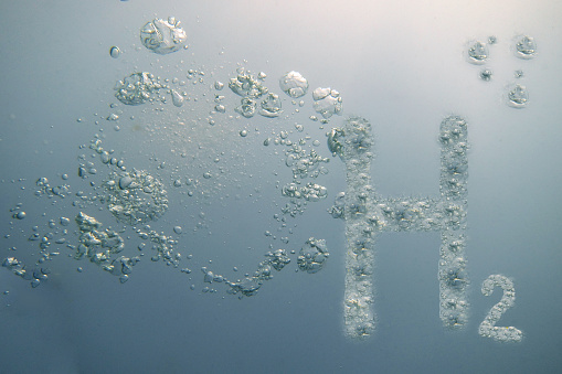 h2 hydrogen letters in light blue water with many littel bubbles