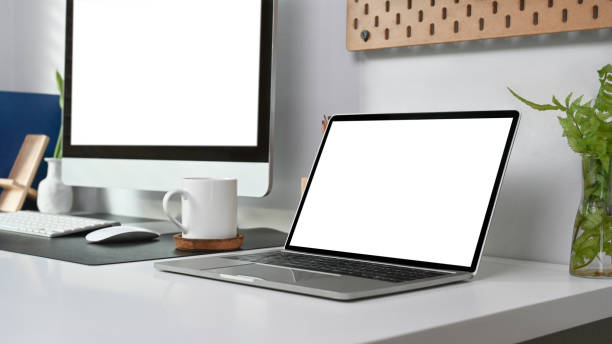 istock Modern workspace with laptop, computer, coffee cup and houseplant at home office. 1316562767
