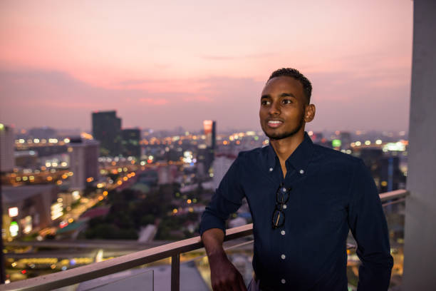 istock African businessman outdoors at rooftop at night smiling and thinking 1316563022