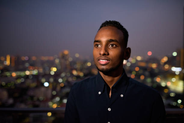 istock African businessman outdoors at rooftop at night smiling and thinking 1316563048