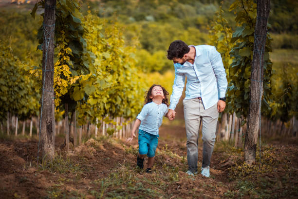 istock Father and son walk through the vineyard. 1316566038