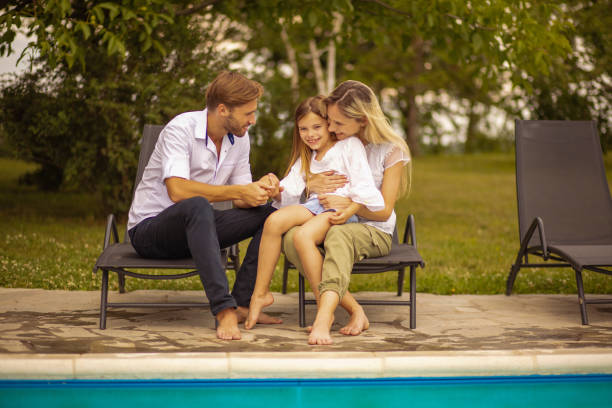 istock Family sitting by the pool. 1316566172