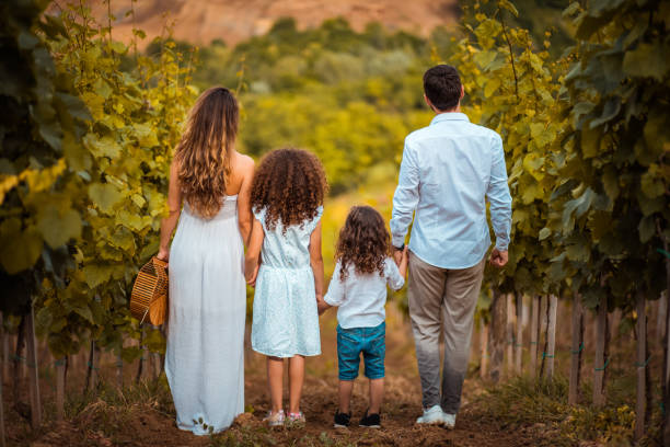 istock Family standing in vineyard. 1316566679