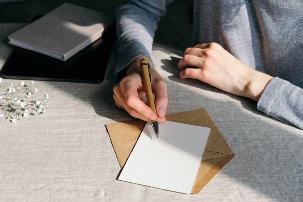 istock Woman writing romantic letter or wedding invitation card 1316567522