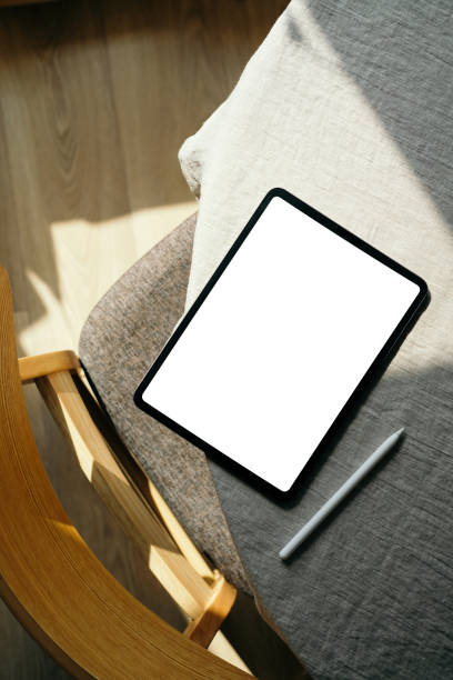 istock Scandinavian, nordic style home office desk workspace with blank screen tablet mockup and drawing pencil. Flat lay, top view 1316569047