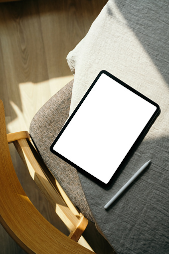 Scandinavian, nordic style home office desk workspace with blank screen tablet mockup and drawing pencil. Flat lay, top view