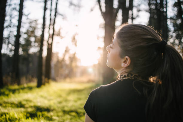 istock Young woman meditating in nature 1316569803