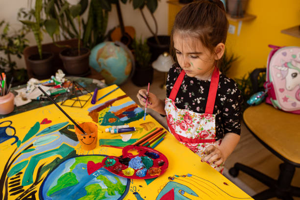 istock Girl in a painting action 1316570883