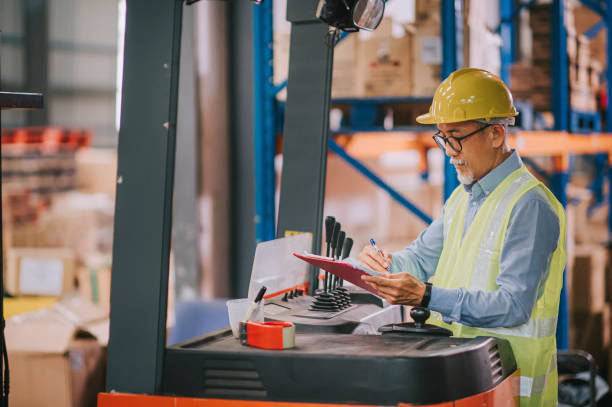istock asian chinese warehouse senior worker at forklift writing updating document working in industry factory 1316571137