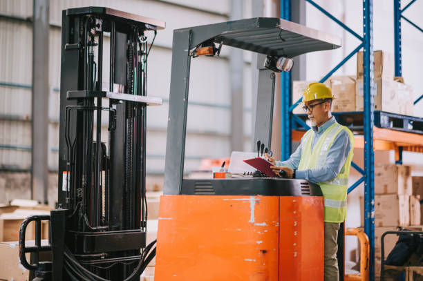 istock asian chinese warehouse senior worker at forklift writing updating document working in industry factory 1316571169