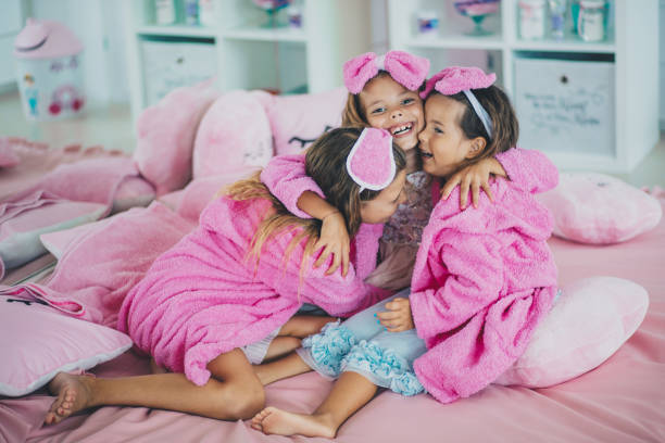 istock Three little girls on bed in hug. 1316571311