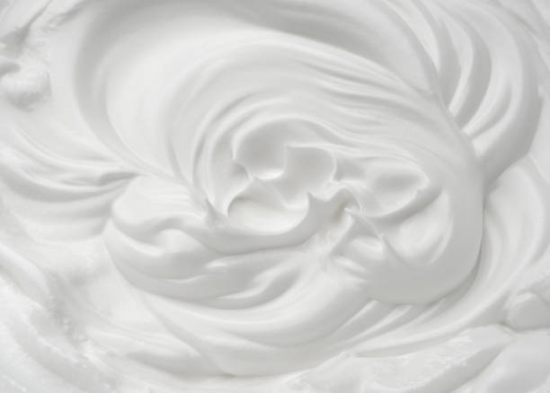 istock Waves of white eggs cream, dairy yogurt close-up. 1316571415