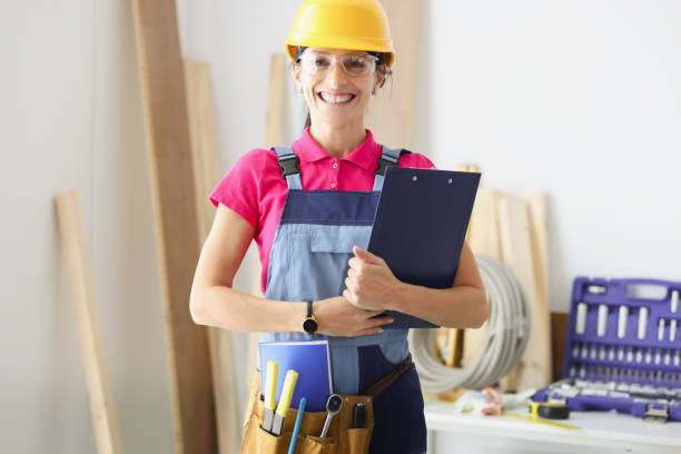 istock Smiling woman builder holds clipboard with documents in her hands 1316573659