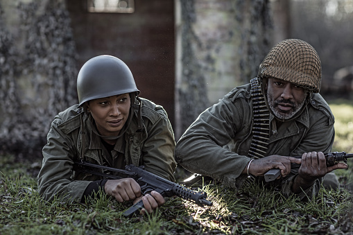 A black captain soldier and mixed race female agent during an outdoor operation in the autumn