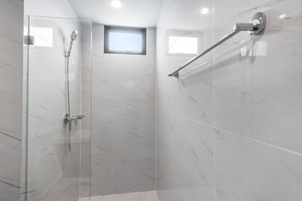 istock White Modern Bathroom with Shower Cabin and Tile Backgrounds in Apartment 1316573959