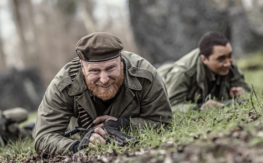 A redhead individual military male soldier during an outdoor operation in the autumn