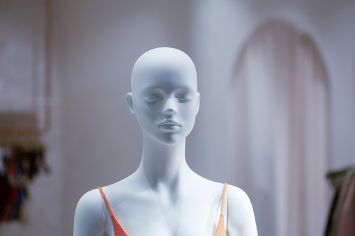 Mannequin in the window of a fashion store. Shopping, discounts, sales concept. High quality photo