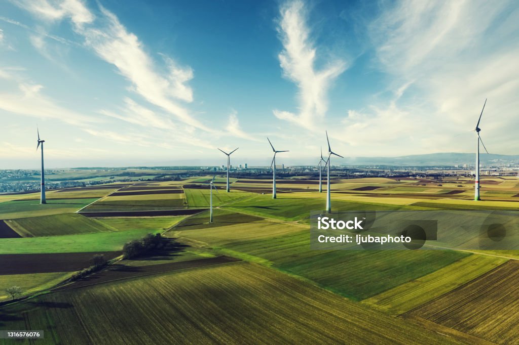 Photo of wind turbines at a rural windfarm. Group of windmills in a wind farm creating renewable energy Wind Turbine Stock Photo