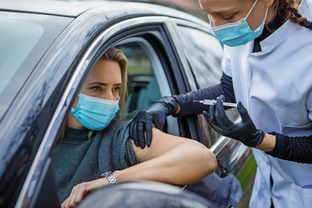 istock Covid-19 Vaccination administered at a drive-in medical facility 1316576255