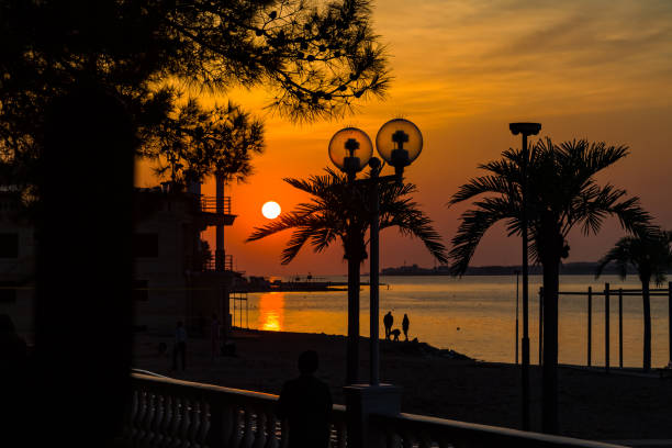 orange sunset on the beach, the sun sets over the horizon