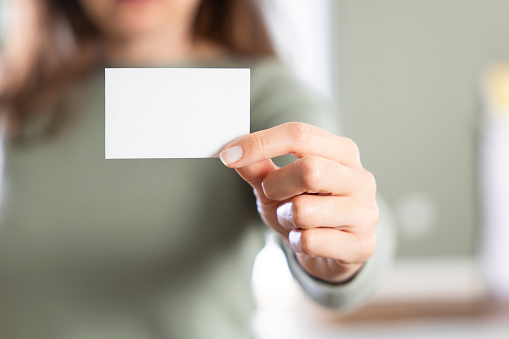 Close up of unrecognizable business woman showing an empty business card