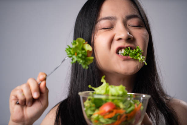 istock First impression Asian woman eating salad. 1316577440