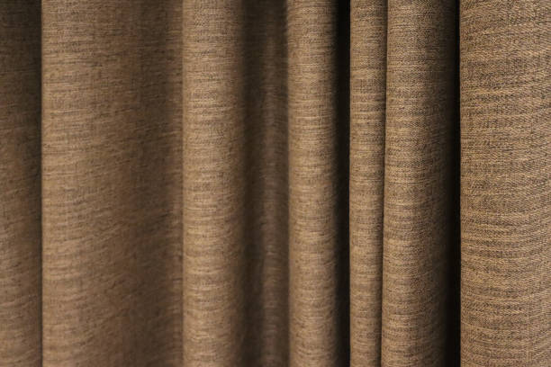 istock Background image of a brown drapery curtain with deflection. 1316577758