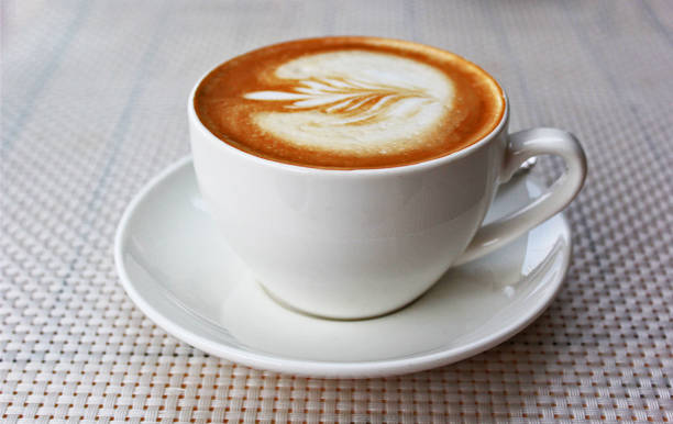 istock Hot art latte coffee in a cup on a white table 1316578685