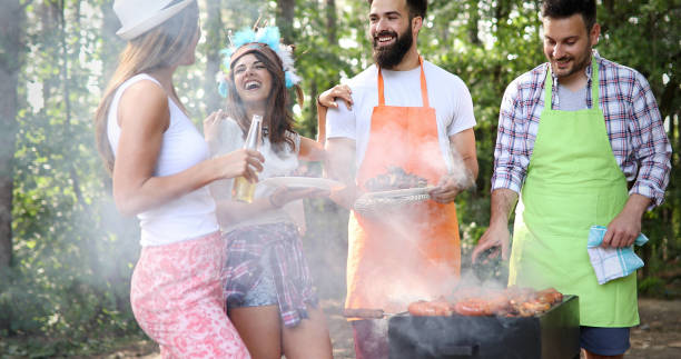 istock Friends having a barbecue party in nature 1316579071