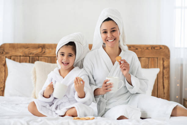 istock Cheerful mummy and kid drinking tea, eating cookies 1316579501