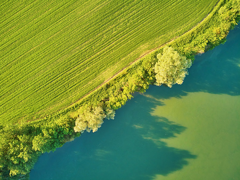 Scenic aerial view of the Seine river and green fields in French countryside. Val d'Oise department, Ile-de-France, Northern France