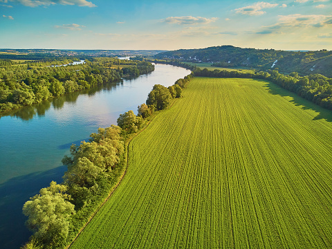 Scenic aerial view of the Seine river and green fields in French countryside