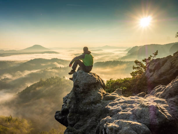 Hiking On Mountain Ridge In The Summit Of Clouds. A Happy Man Silhouette Alone Photo taken in Bad Schandau, Germany view from mountain top stock pictures, royalty-free photos & images