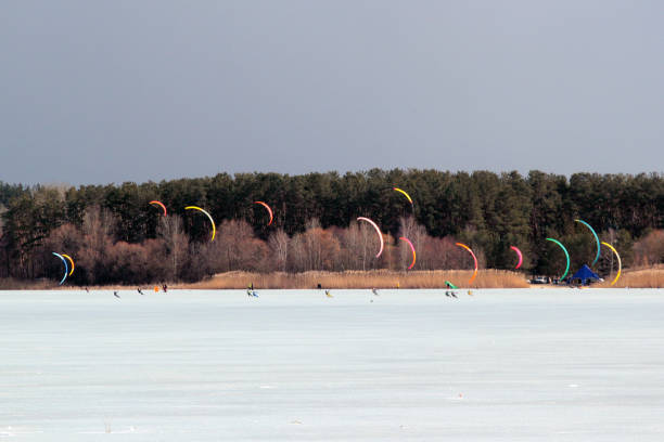 Snowkiting sport competition on a frozen lake