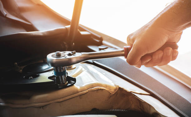 istock Hand is unscrewing with the socket wrench 1316580940