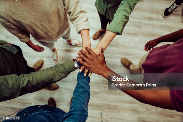 Business Colleagues Putting Their Hands Together In Office Room Making Piles Of Hands Showing Unity And Team Work Stock Photo - Download Image Now