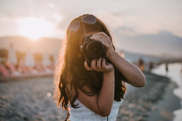 istock Woman taking photo at the beach 1316582663