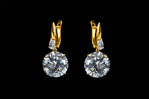 Beautiful gold diamonds earrings isolated over black