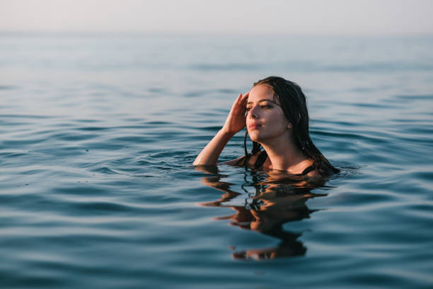 istock Woman posing in sea water 1316583019