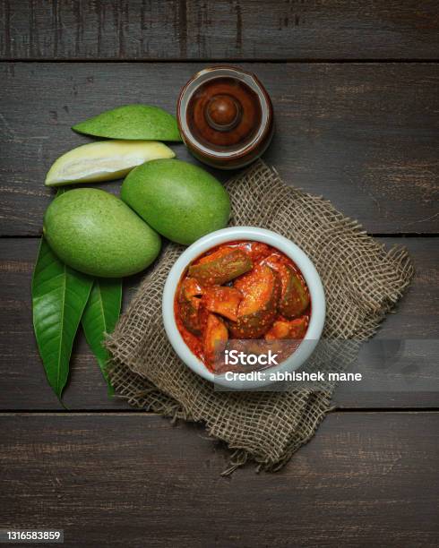Mango Pickle Or Aam Ka Aachar Or Achar In A Bowl On Wooden Background Theme  With Raw Mangos Around That Stock Photo - Download Image Now - iStock