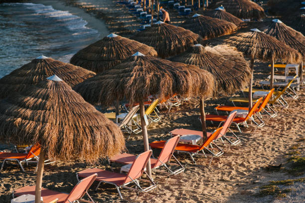 istock Empty deck chairs and reed umbrellas by the sea 1316584020