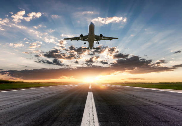 istock Airplane taking off at sunset 1316584129